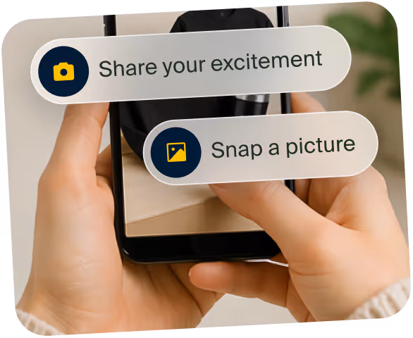 Hands holding a phone with options to share excitement or snap a picture on screen.