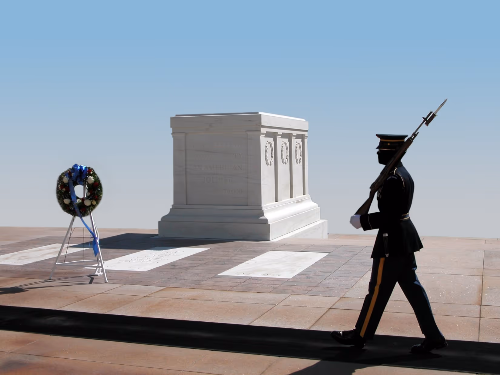Guard standing near a memorial, representing stewardship, honor, protection, and responsibility.