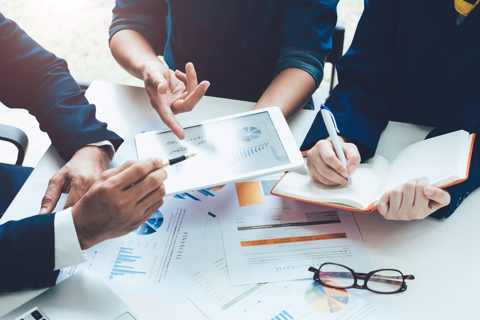People reviewing financial charts while preparing for a larger loan decision