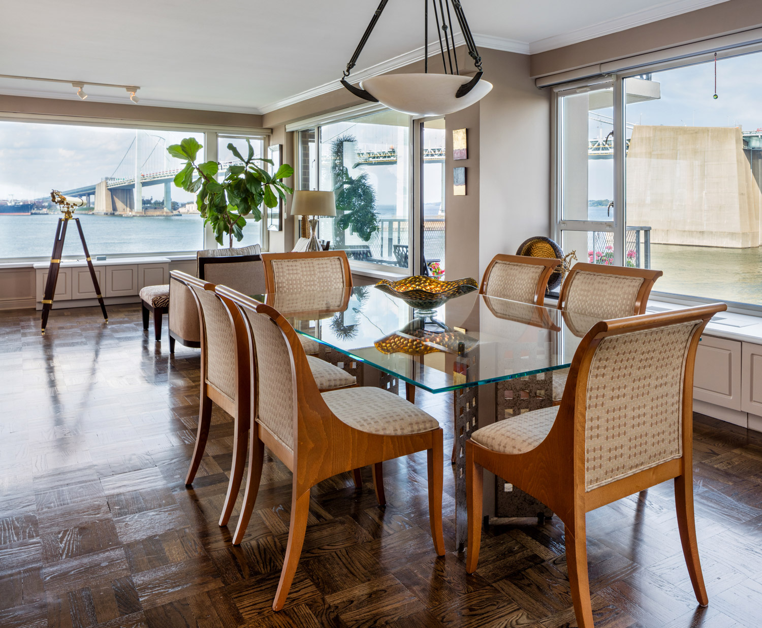 Sunlit waterfront dining with panoramic river views.