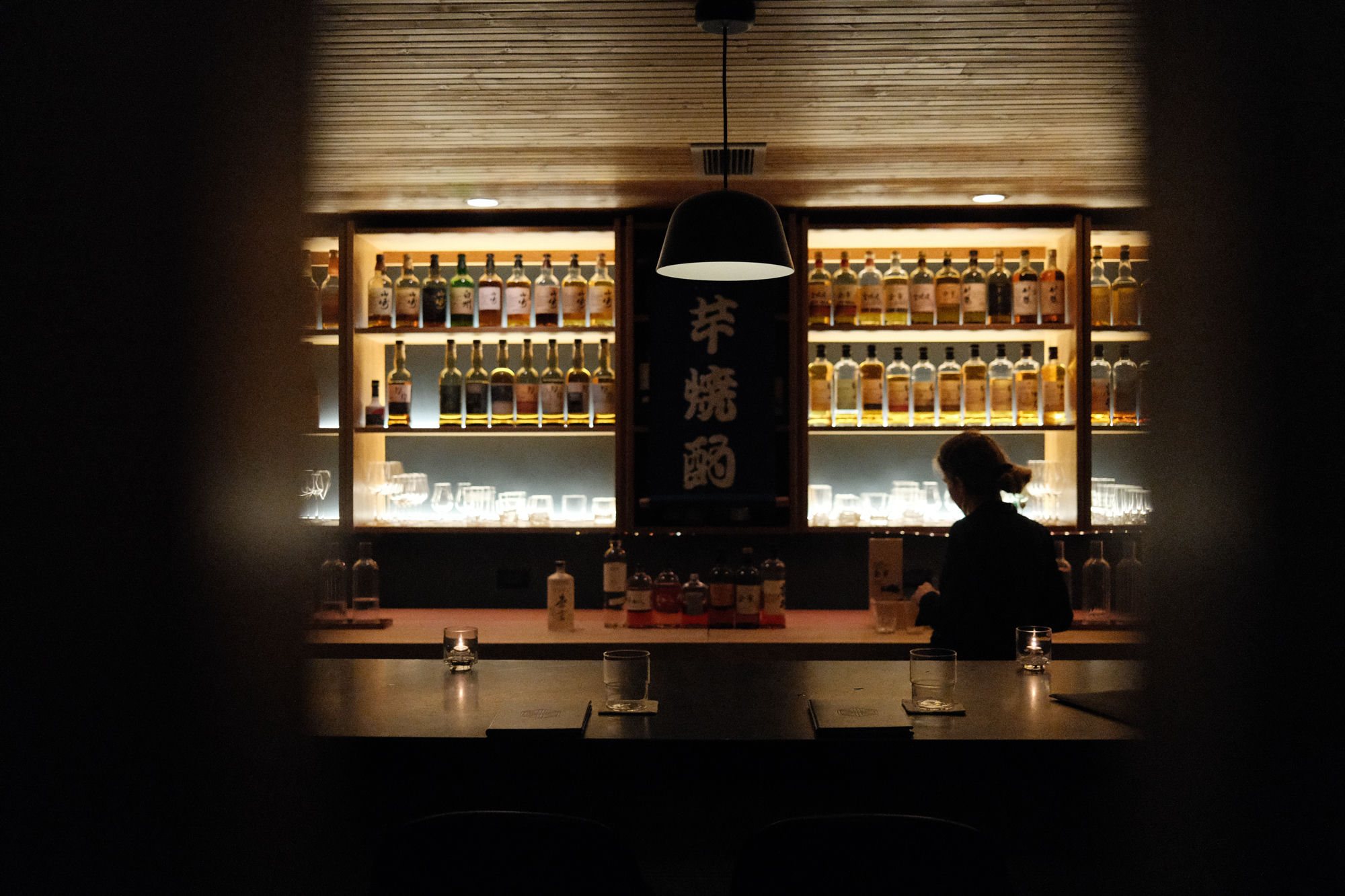 The whisky bar beneath Kumiko, backlit shelves of Japanese whisky