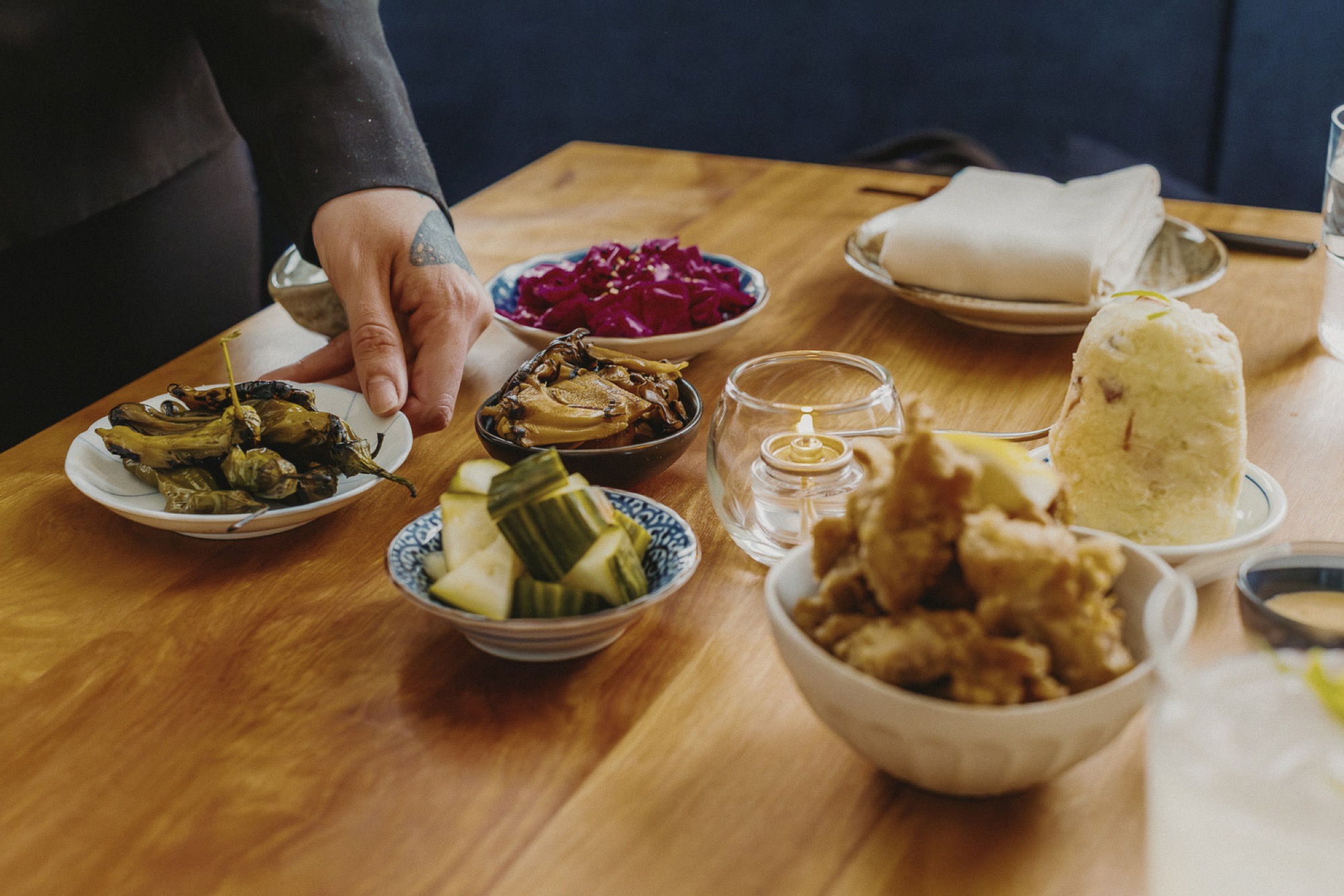 A spread of otsukemono, karaage, and Japanese potato salad on the table