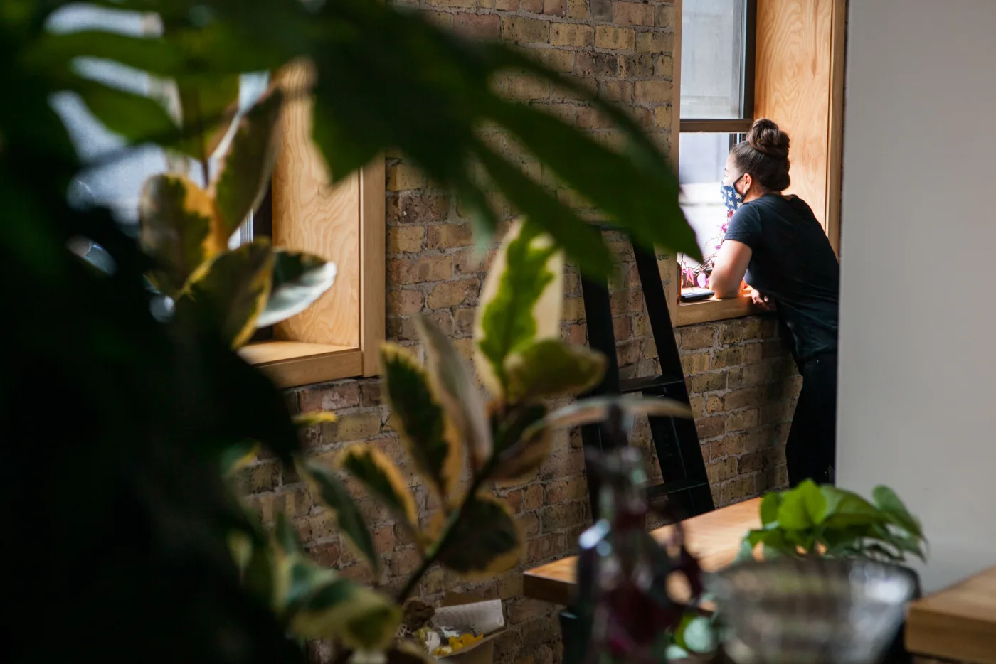 Julia Momosé speaking with a guest through the Café Kumiko service window, 2020