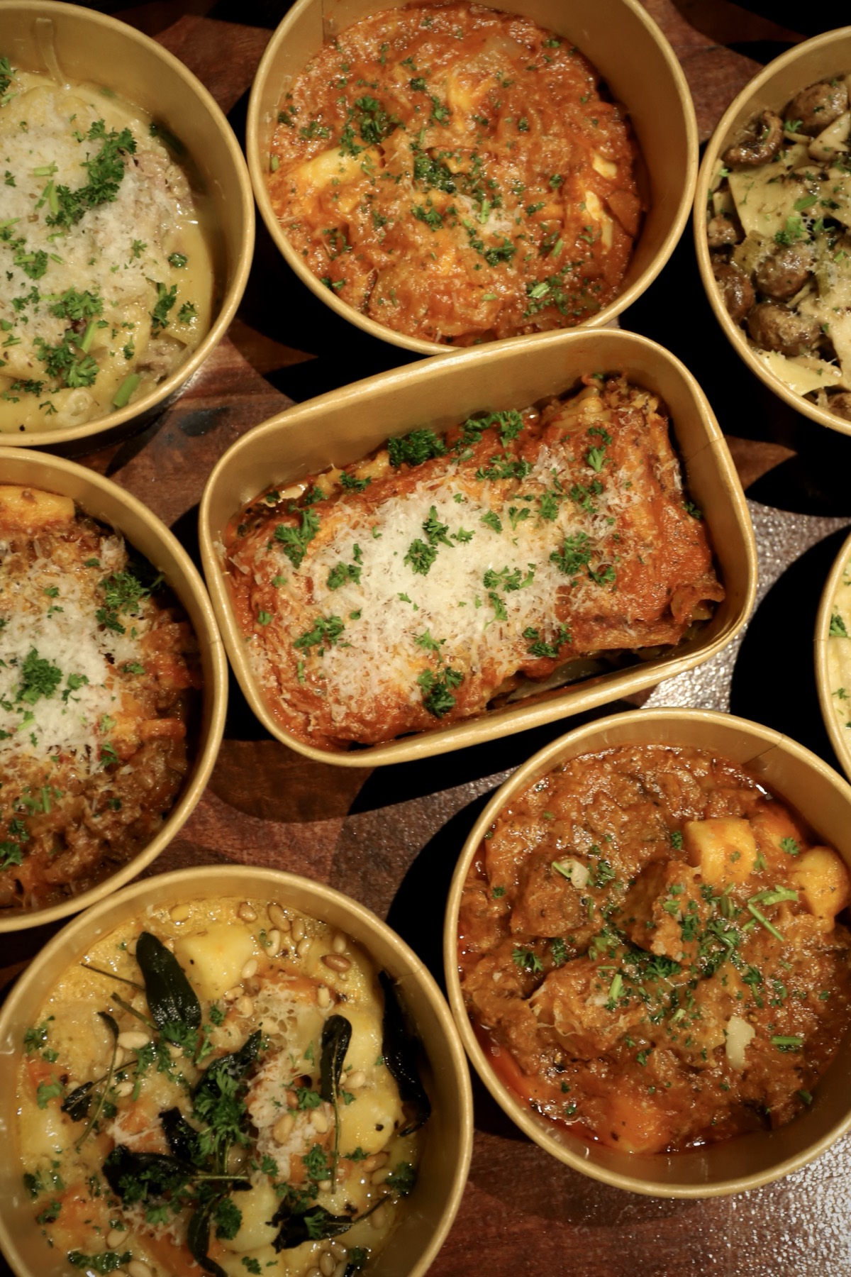 Close overhead view of pasta and lasagne portions at Obertor Pasta Bar