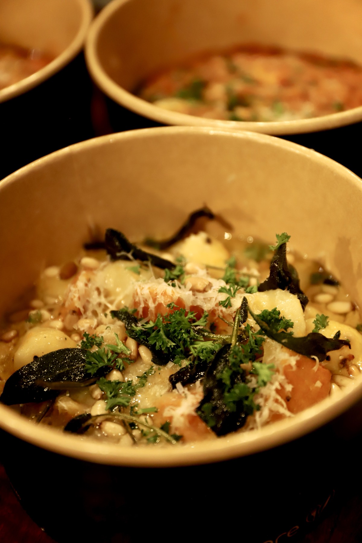 Close up of Obertor Pasta Bar pumpkin gnocchi with sage and pine nuts in its takeaway bowl