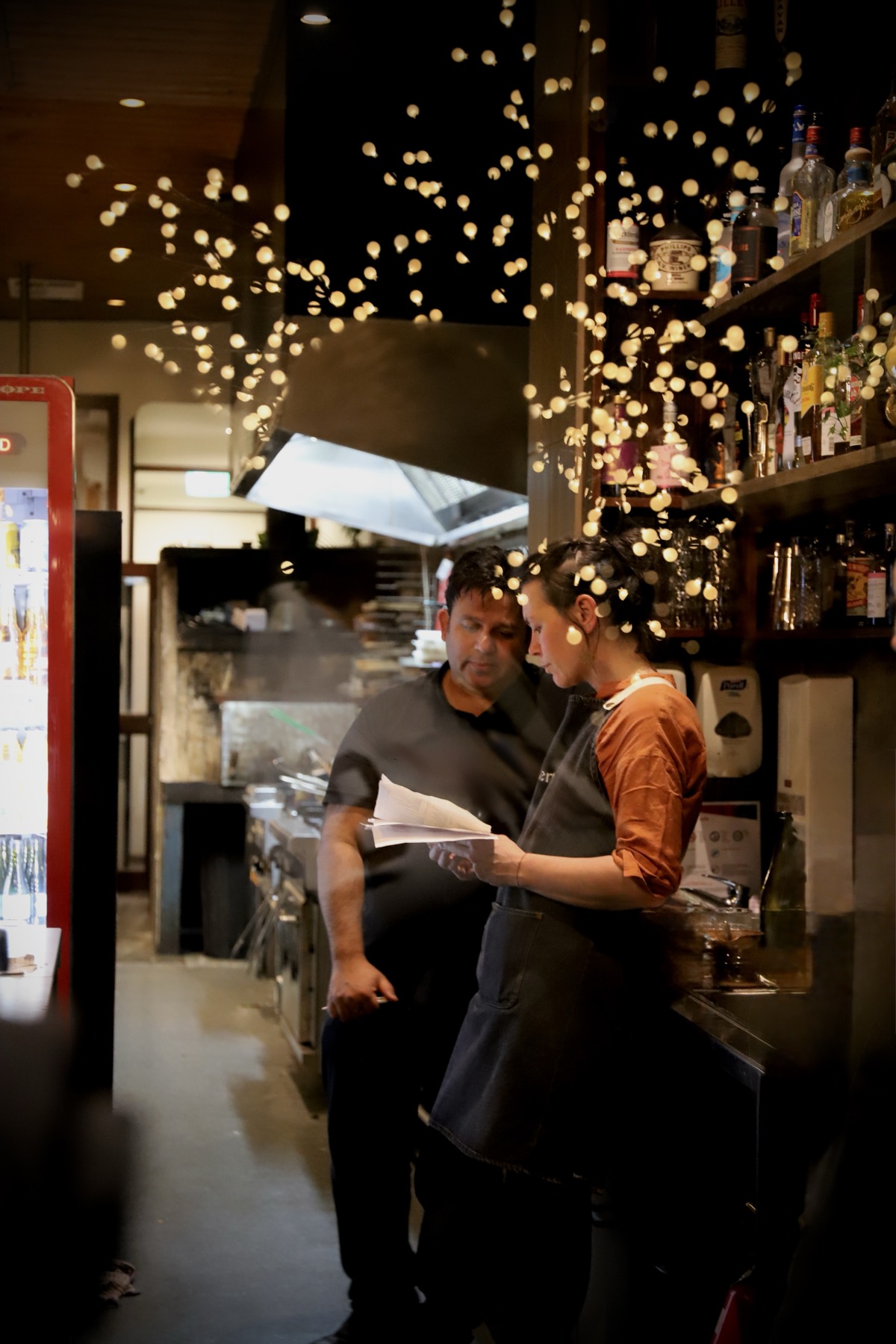 The Obertor kitchen pass in the evening under string lights