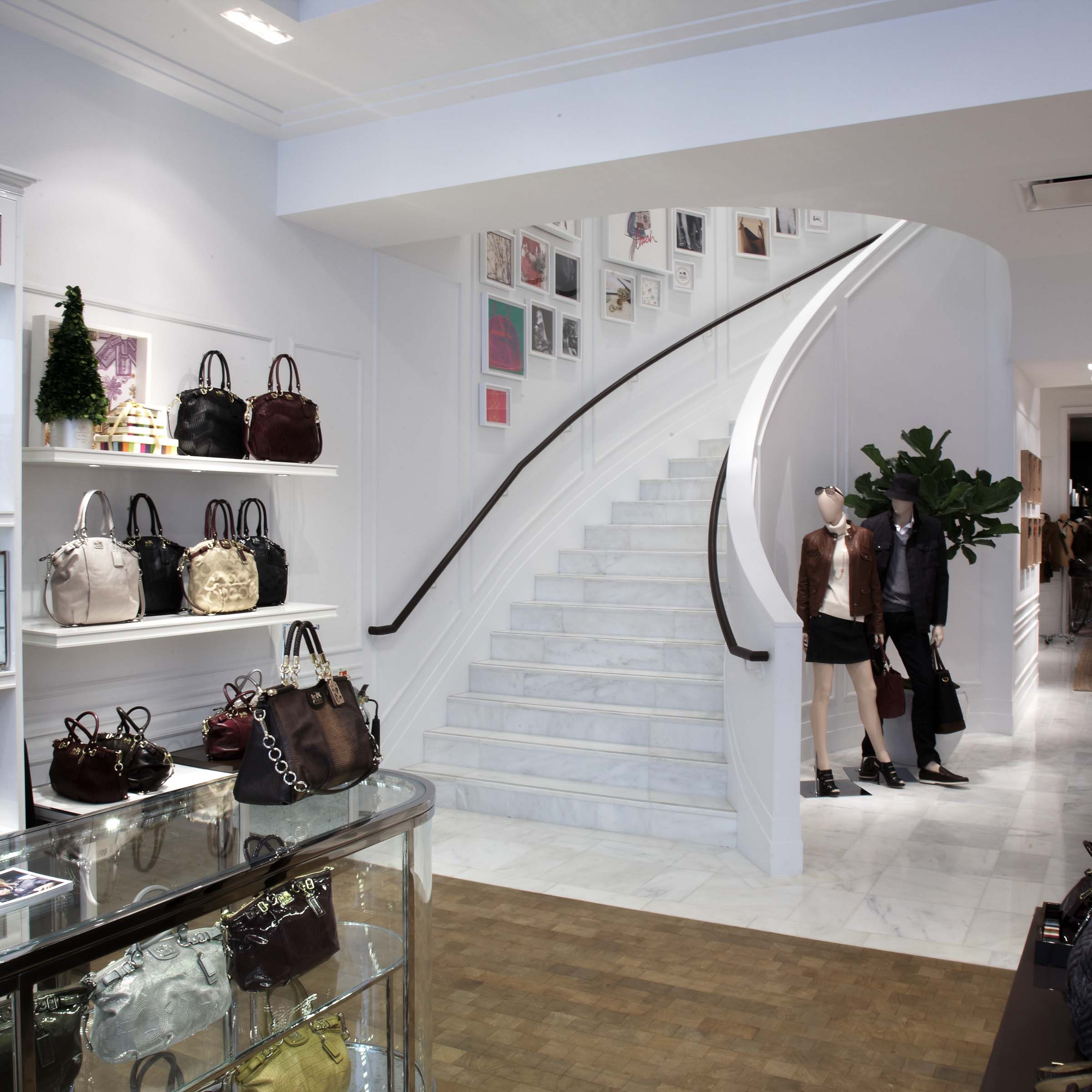 Bespoke natural stone staircase with sweeping curved design and handcrafted iron balustrade