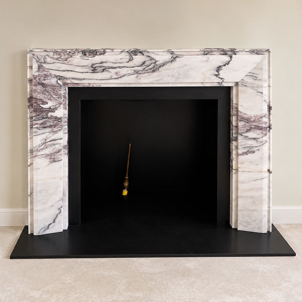 Bespoke natural stone fireplace custom designed and handcrafted by Coulon Stone
