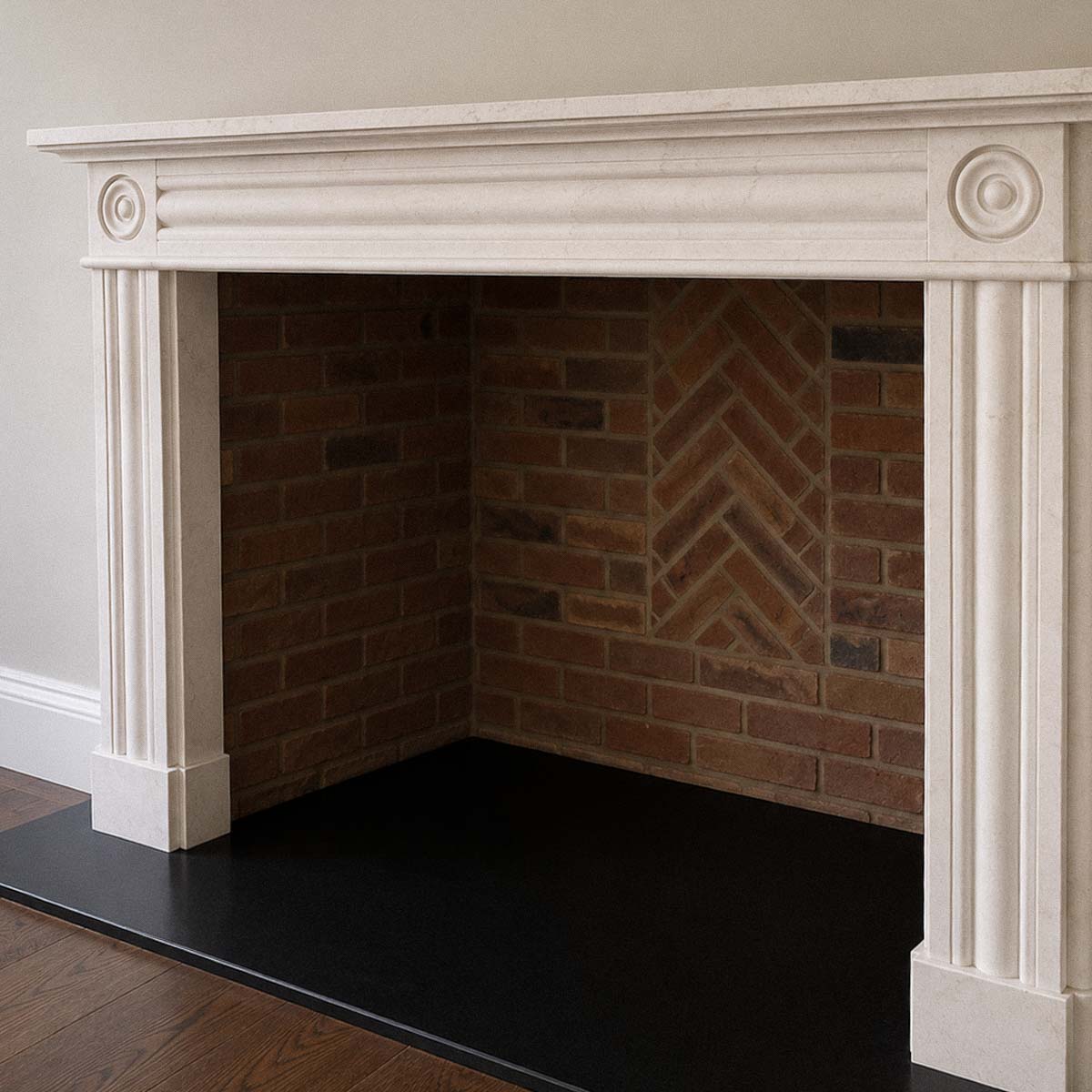 Bespoke natural stone fireplace custom designed and handcrafted by Coulon Stone