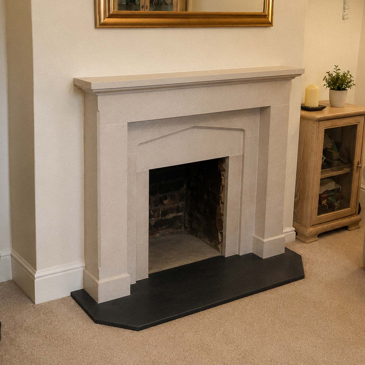 Bespoke natural stone fireplace custom designed and handcrafted by Coulon Stone