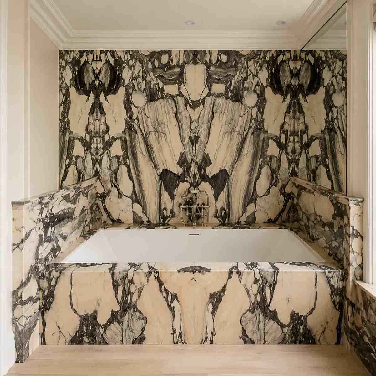 Marble bathroom with integrated vanity and floor-to-ceiling stone wall cladding
