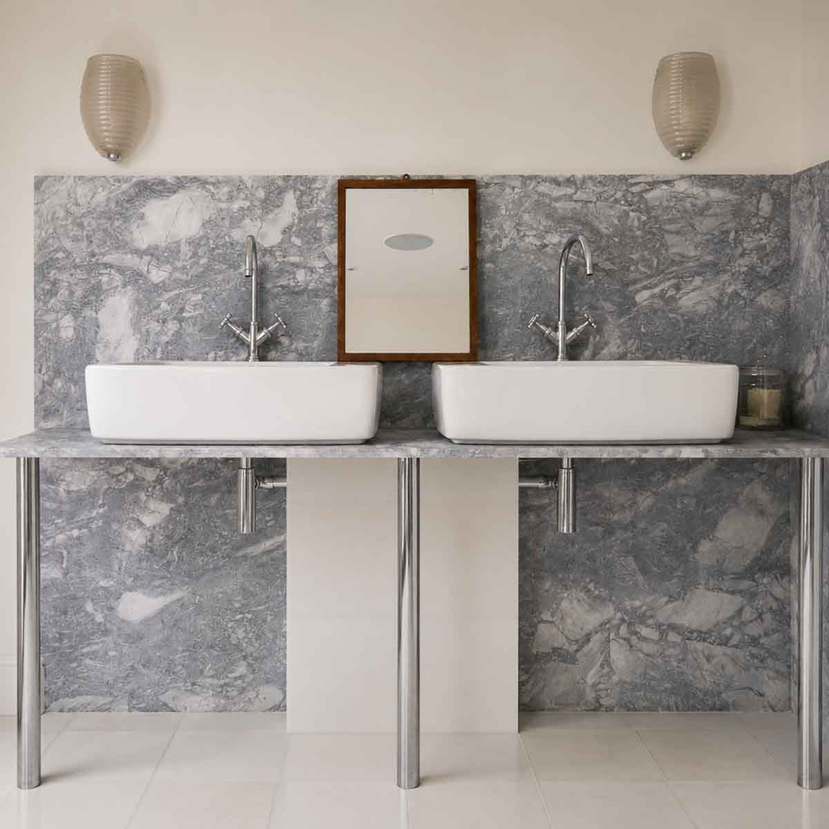 Marble bathroom with integrated vanity and floor-to-ceiling stone wall cladding