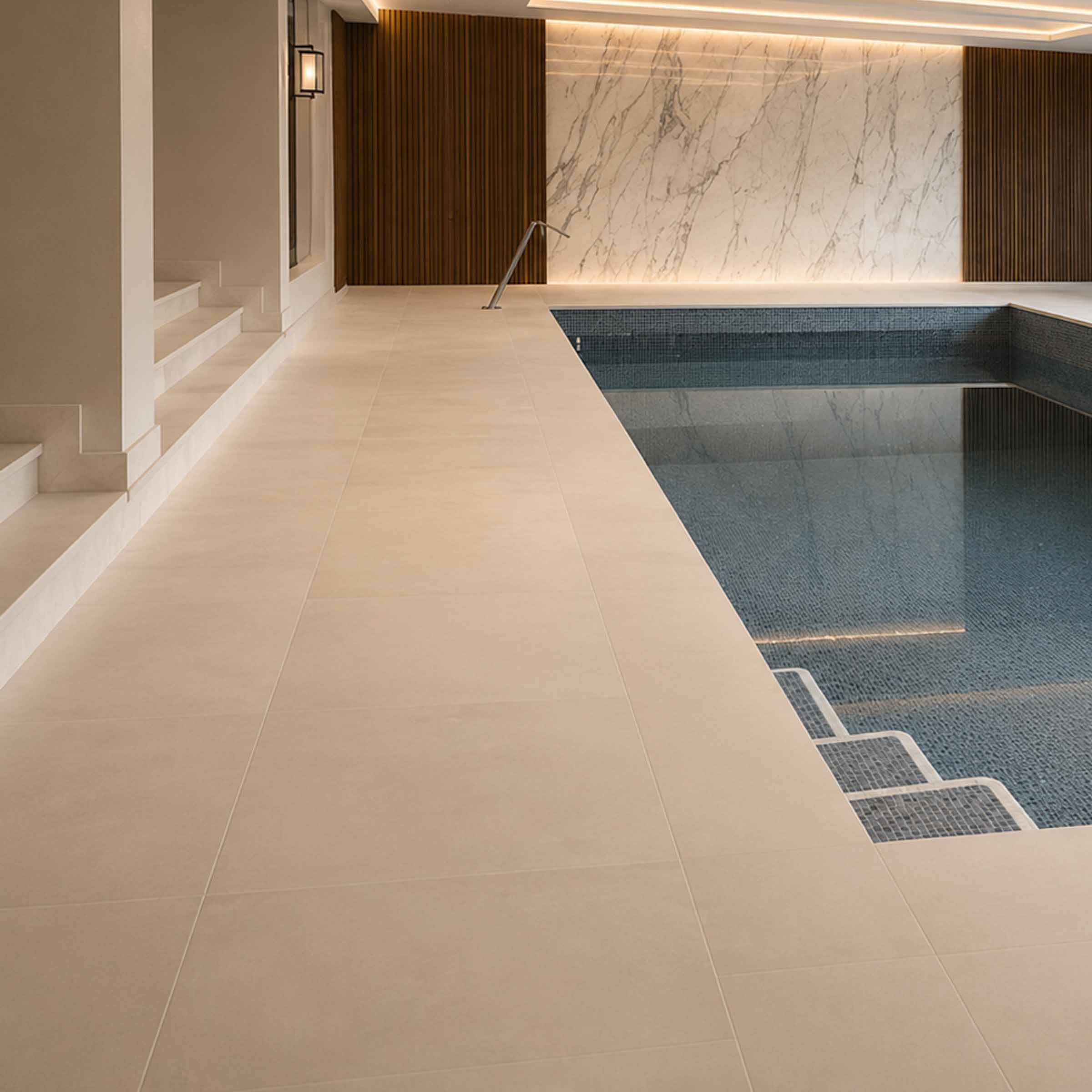 Bespoke natural stone swimming pool surround and flooring designed and installed by Coulon Stone