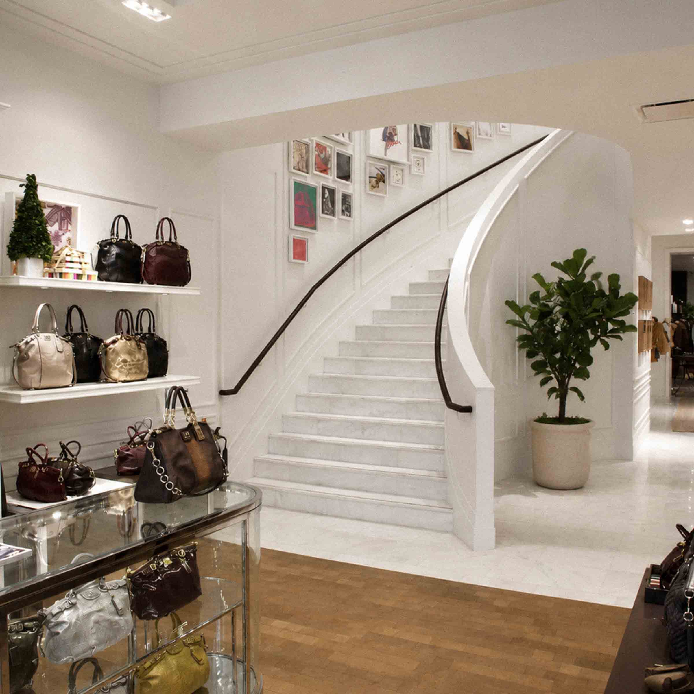 Bespoke marble staircase with sweeping curved design and handcrafted iron balustrade