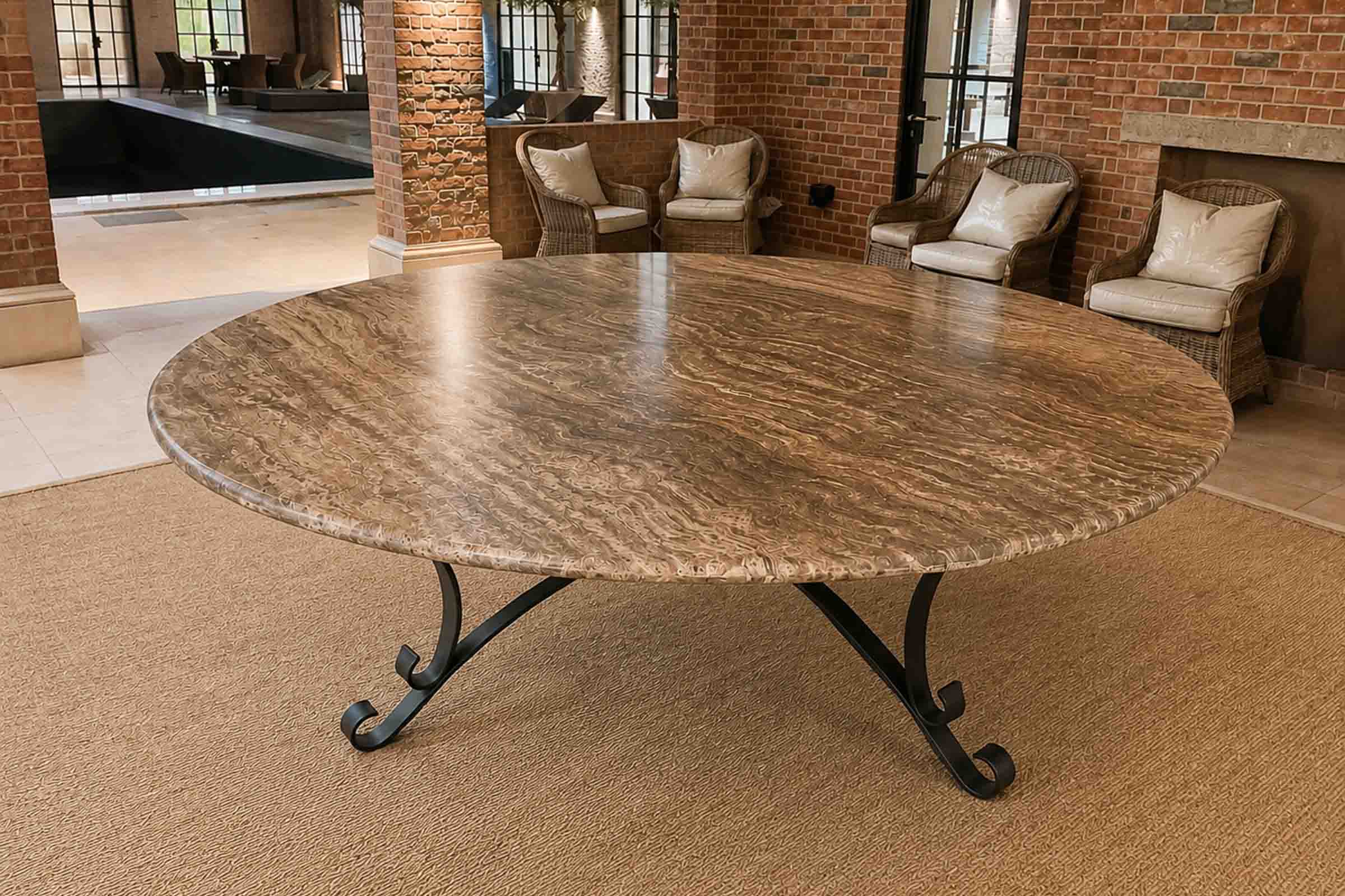 Bespoke round travertine stone table handcrafted for a luxury outdoor living space