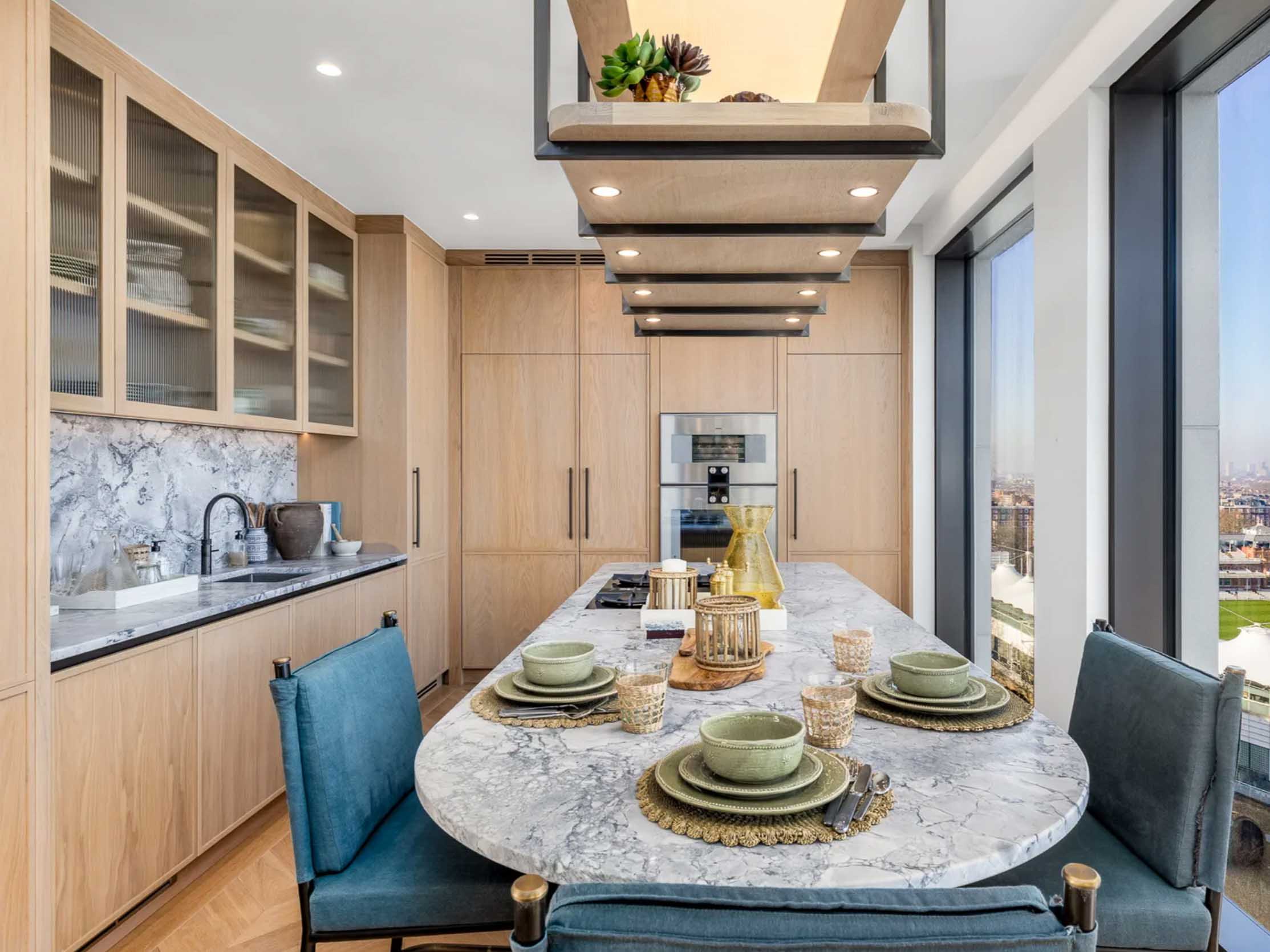 Marble kitchen island and splashback with bespoke cabinetry in a contemporary home