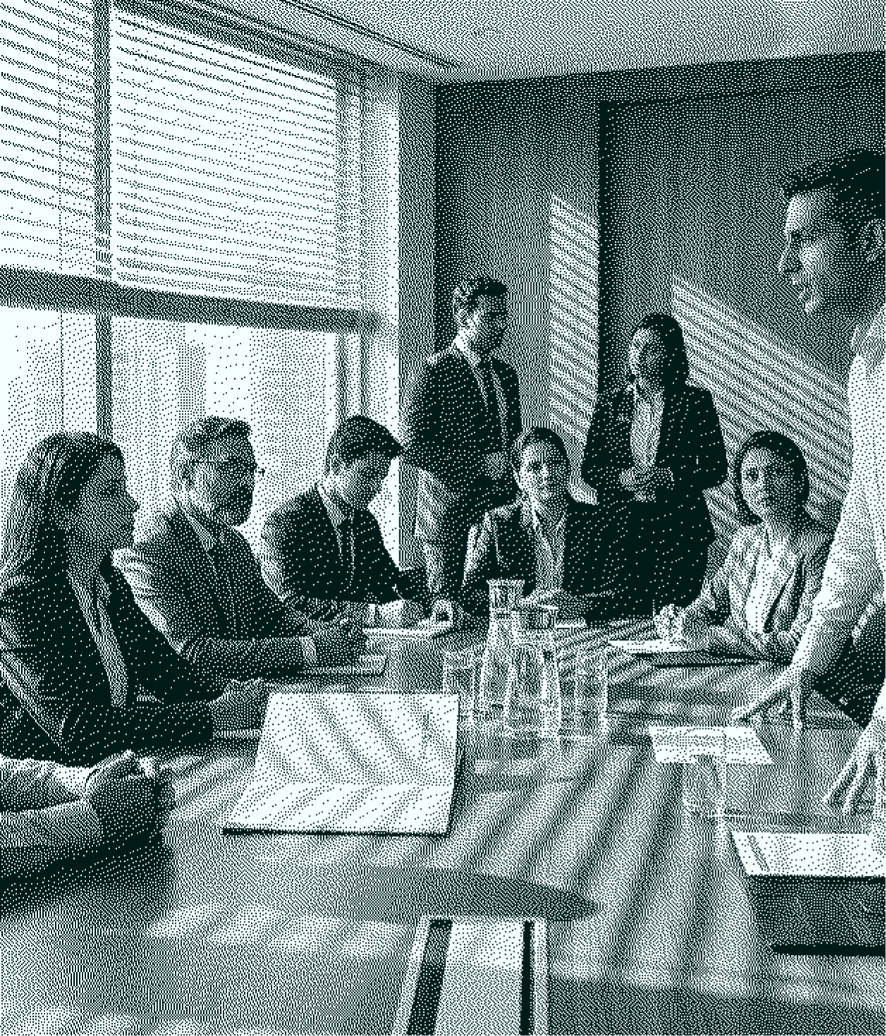Business team in discussion around a conference table in a modern office with sunlight through blinds.