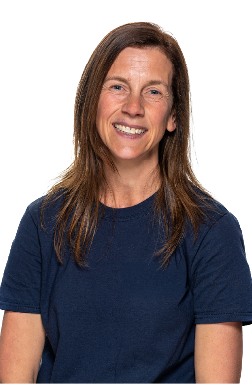 Smiling woman with straight brown hair wearing a navy blue t-shirt against a white background.