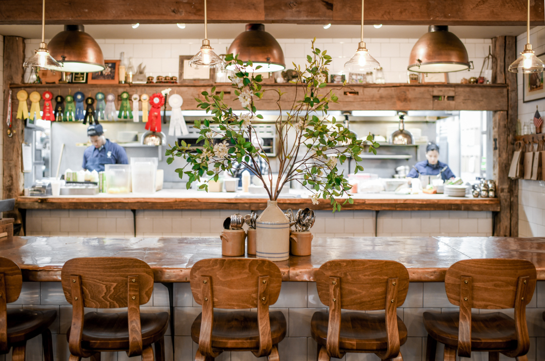A restaurant with a wooden table and chairs.