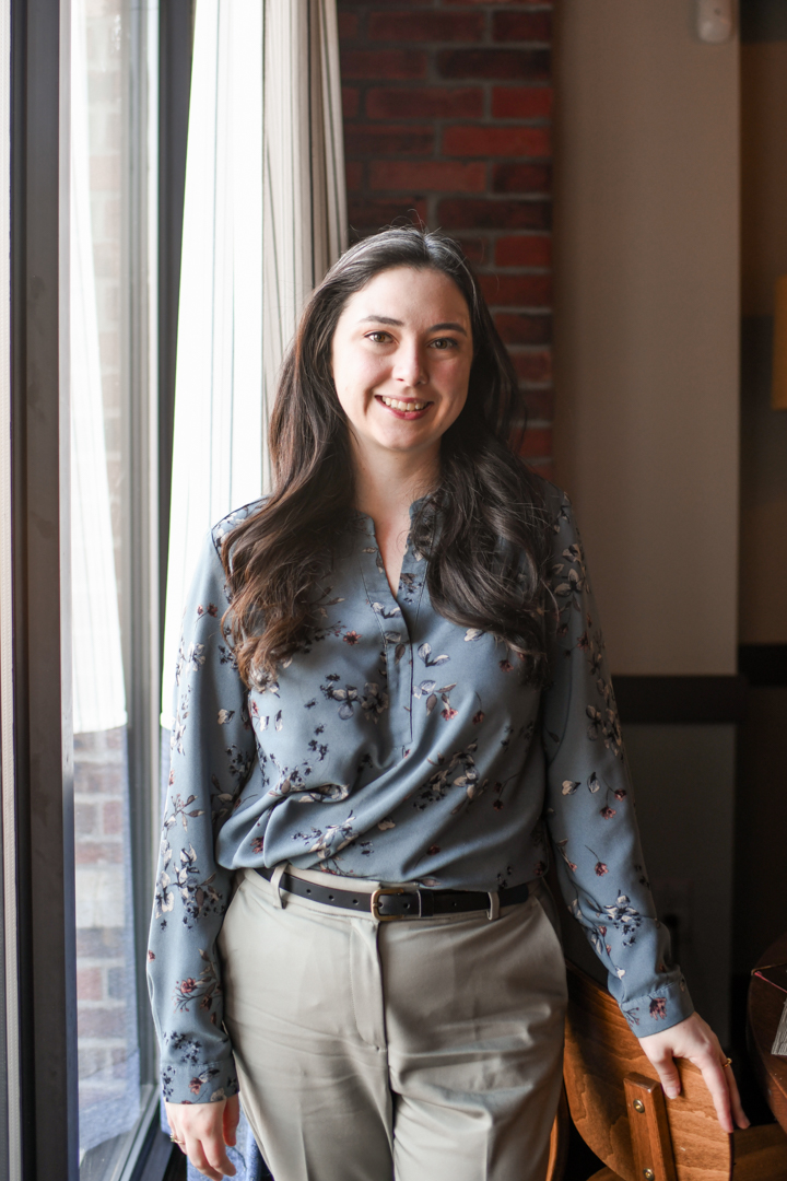 A woman wearing a blue shirt and khaki pants.