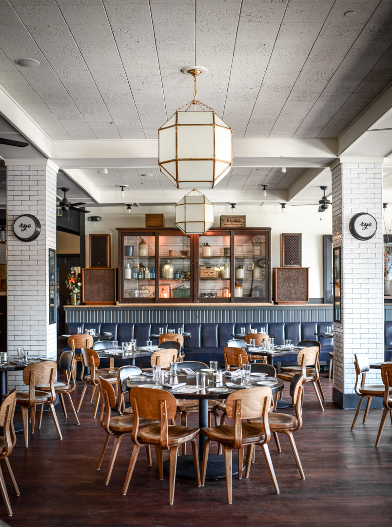 A restaurant with a wooden table and chairs.
