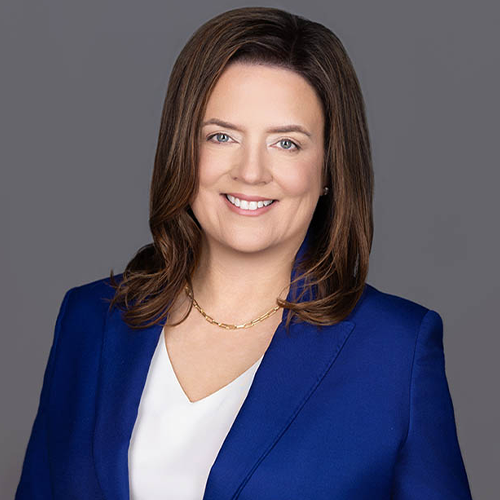 Stacey Zeleznik in a professional corporate headshot with a blue blazer