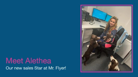 A promotional blog graphic with a dark blue background and pink text reading "Meet Alethea, Our new sales Star at Mr. Flyer!", featuring a framed photo of her at her desk interacting with office dogs.
