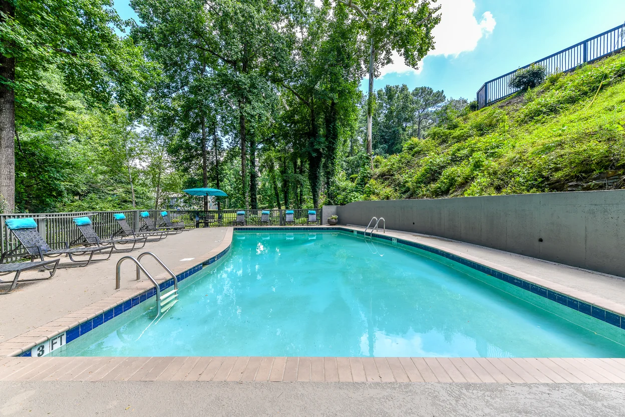 Berry Falls poolside lounge with wooded surroundings