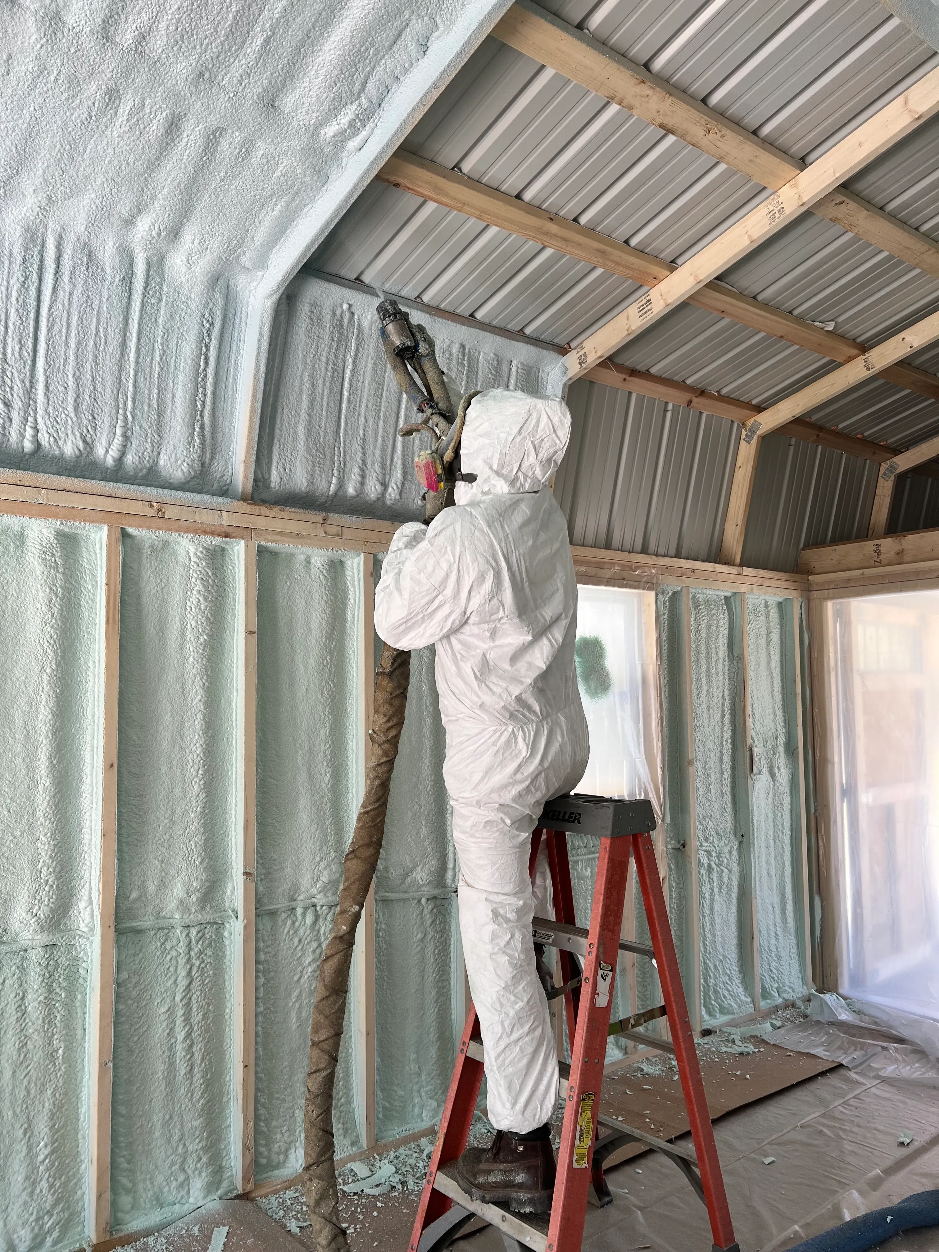 An installer spraying foam