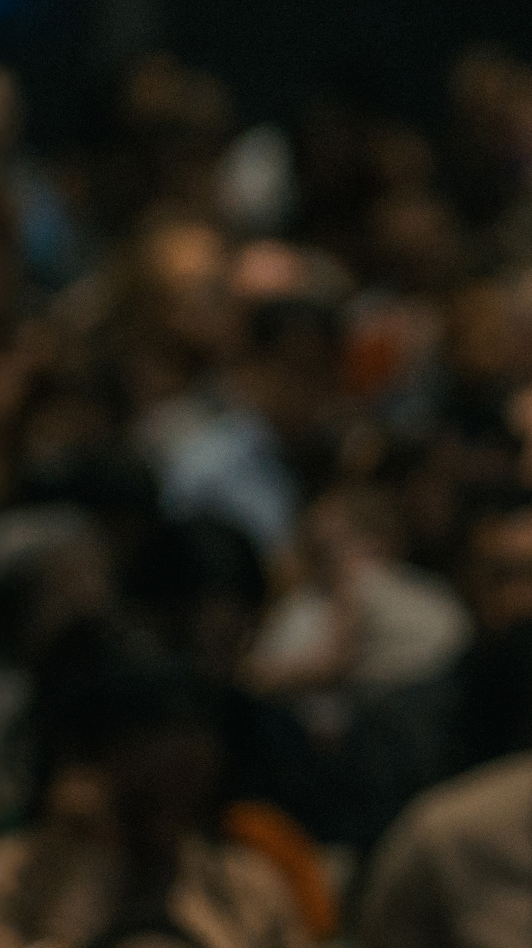 Blurred image of a large Church audience seated and looking at the pastor