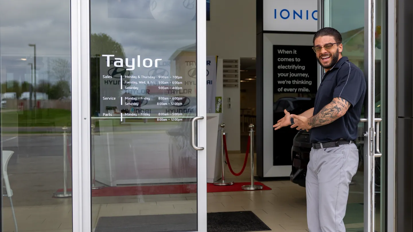 Anthony Ross at Front door to Taylor Kia.