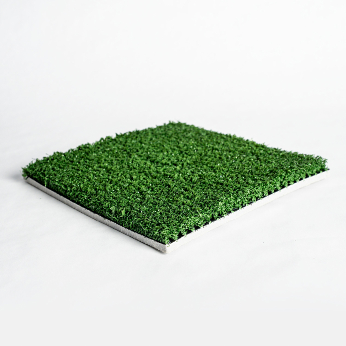 Rectangular sample of artificial turf with green and brown strands on a white background.