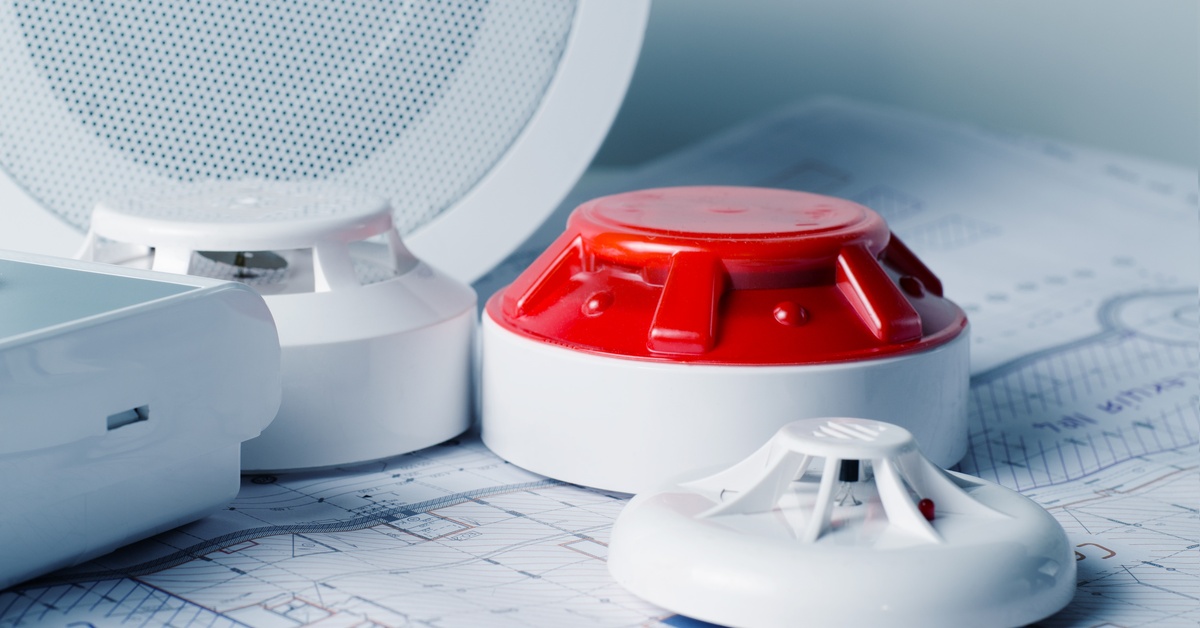 Several fire alarms on a counter. 