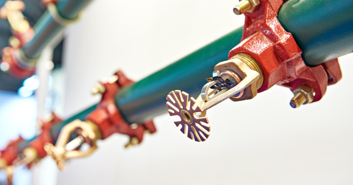 A fire sprinkler pipe with several fire sprinkler heads. 