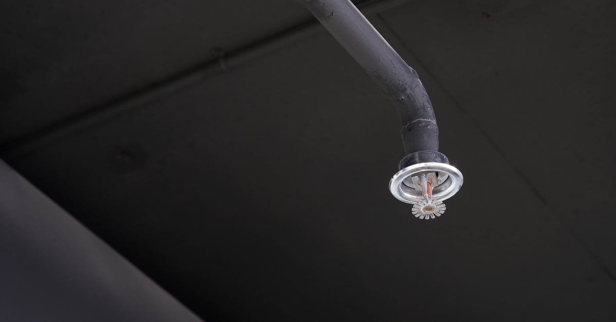 A fire sprinkler in dark lighting. 