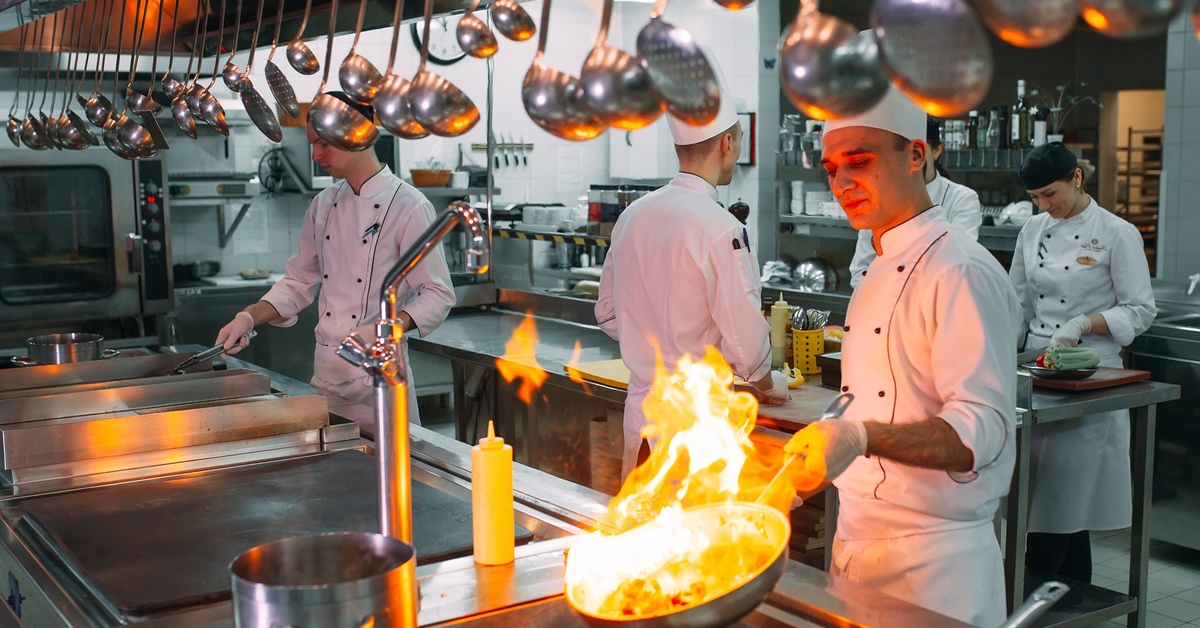 A kitchen full of chefs cooking. 