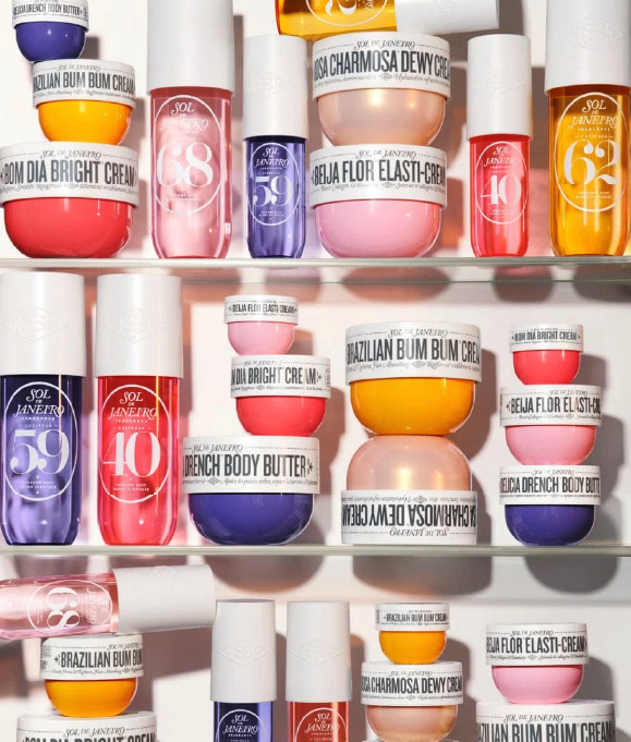 Various Sol de Janeiro skincare products including creams and body butters arranged on glass shelves.