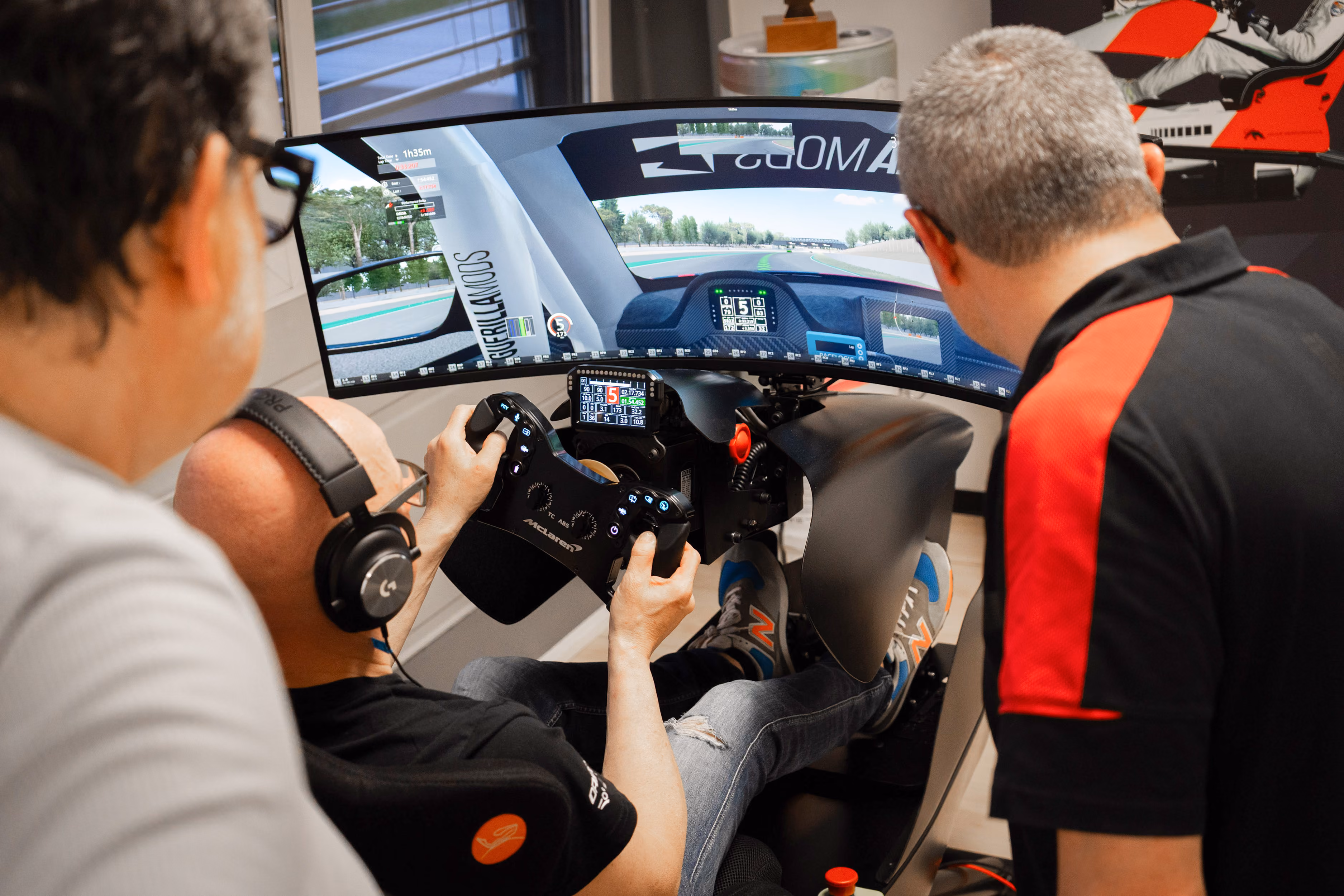 Ein Fahrer im Simulator wird von einem Coach begleitet und beobachtet