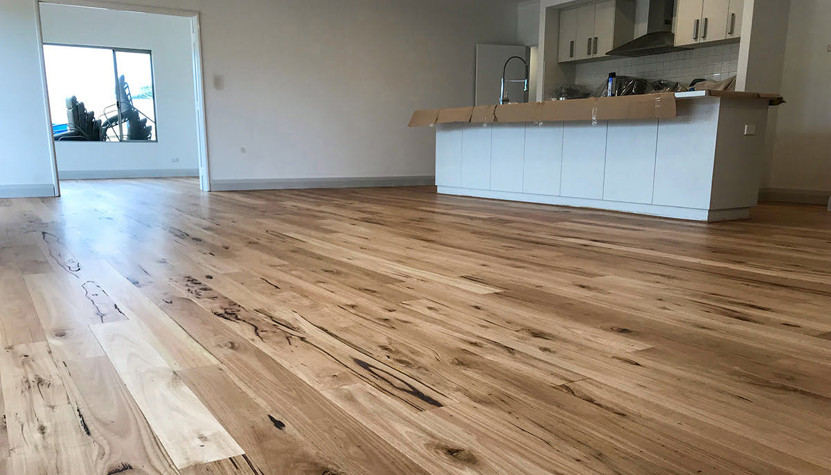 Sanded and sealed character grade floor in a bright living area by Brazil Floors