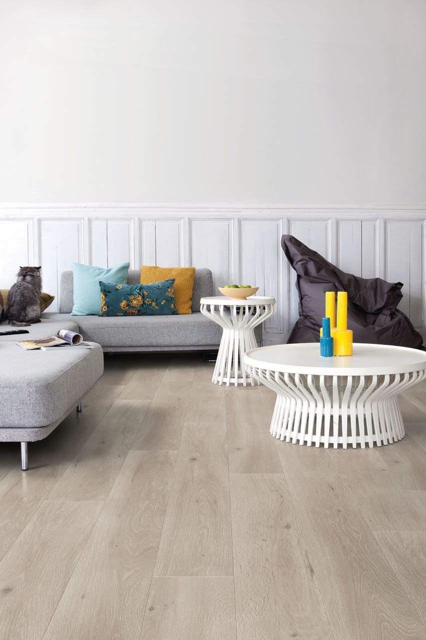 Light gray laminate floor in a white living room by Brazil Floors