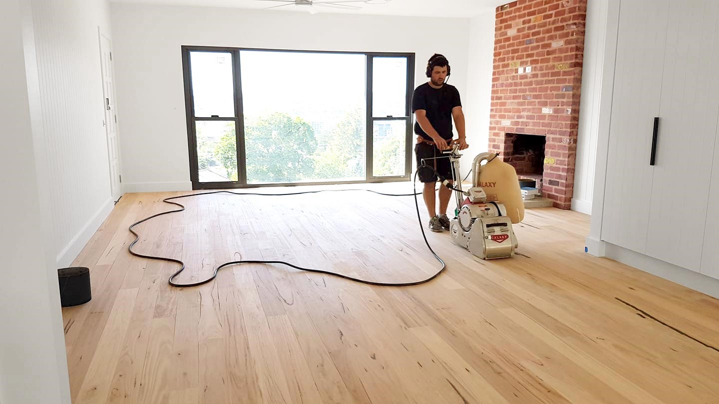 Floor sanding in an empty room after board repairs by Brazil Floors