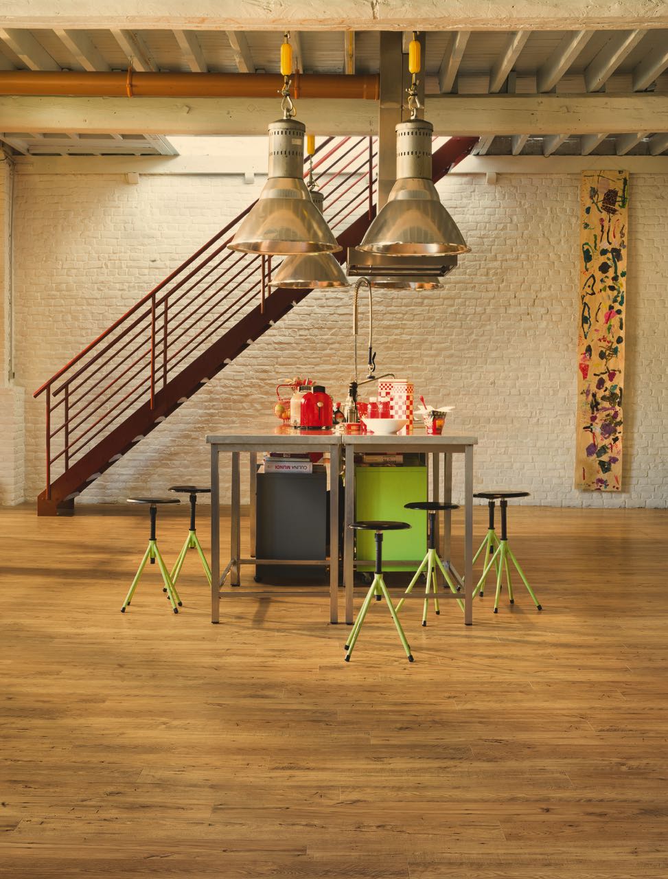 Wide plank laminate under a kitchen island in an open loft by Brazil Floors
