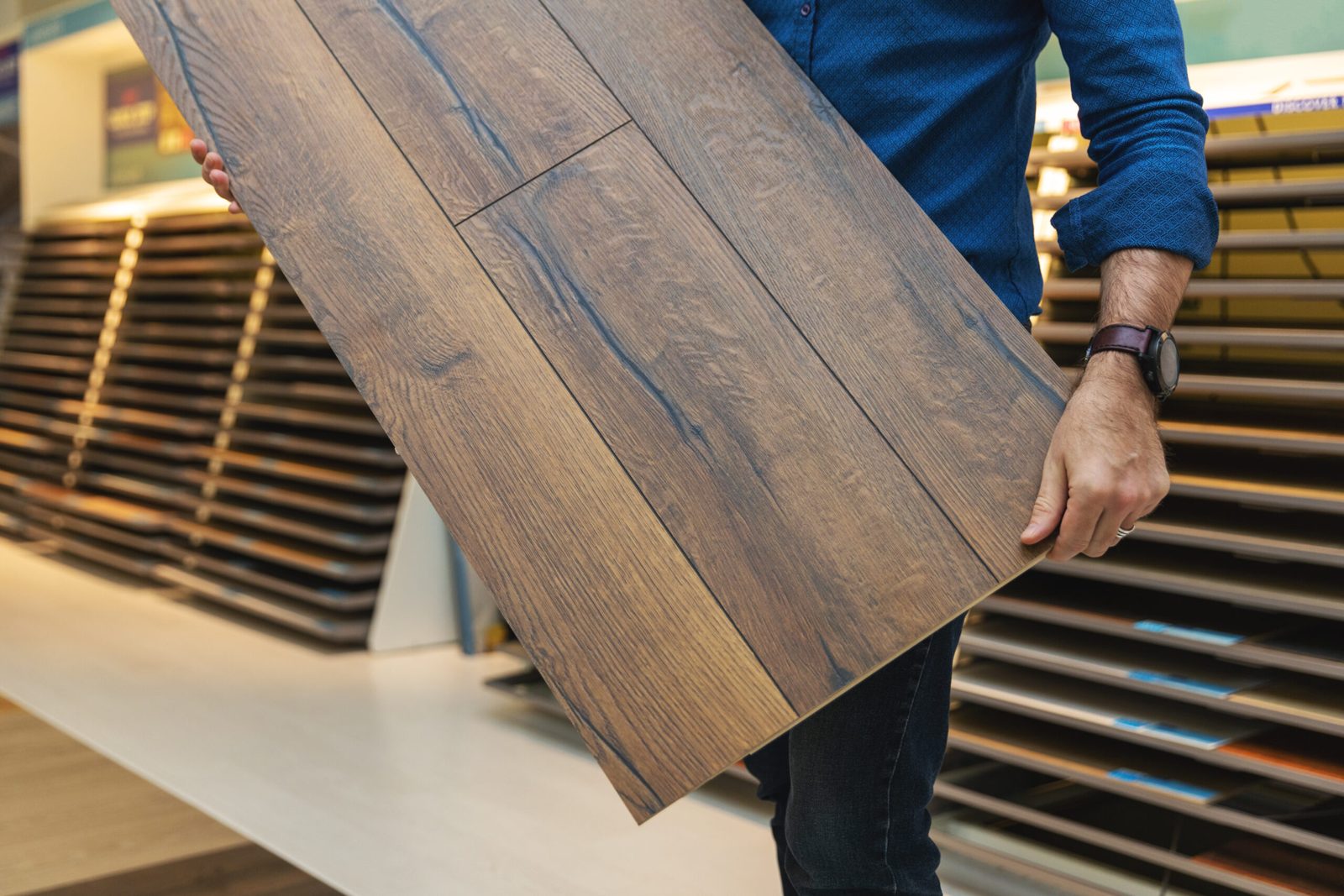 Hardwood plank sample held up in a flooring display by Brazil Floors