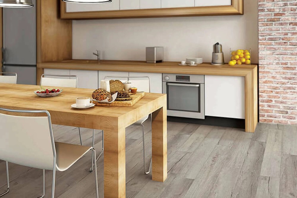 Chesapeake Oak COREtec Pro 7 inch LVP in a kitchen with a brick wall by Brazil Floors