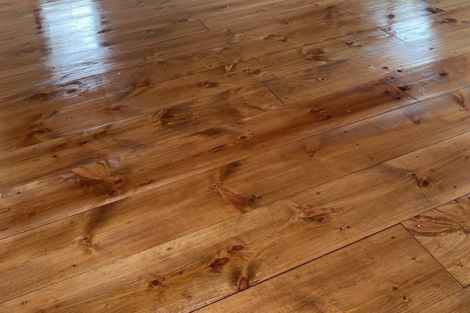 Pine floor with a high shine in a bright room with glass doors, Brazil Floors