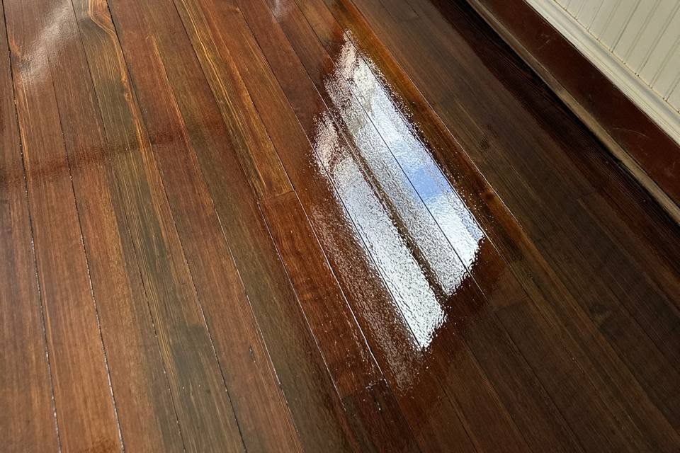 Glossy pine floor beside a radiator and window, Brazil Floors