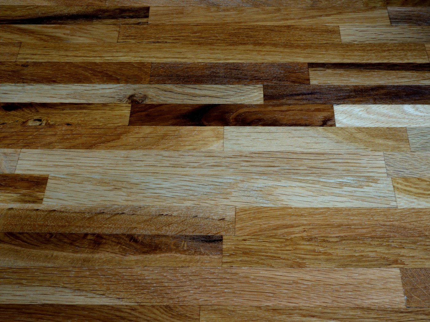 Close view of straight lay hardwood with planks in mixed oak tones running side by side, Brazil Floors