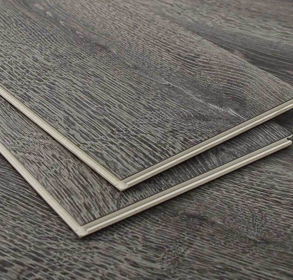 Two gray luxury vinyl planks showing the click lock edge and wear layer, Brazil Floors