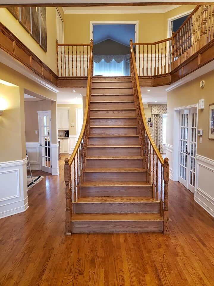 Refinished oak staircase and entry hall with a fresh polyurethane finish in Coventry, RI