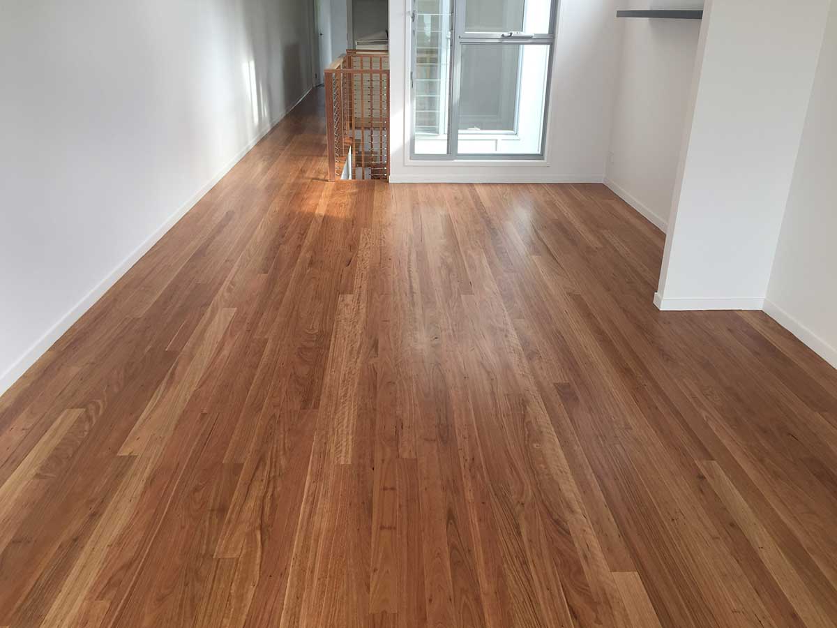 Satin oak floor refinished down a bright hallway in a Johnston, RI home